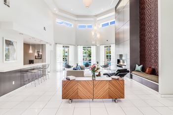 A modern living room with a wooden cabinet in the middle.